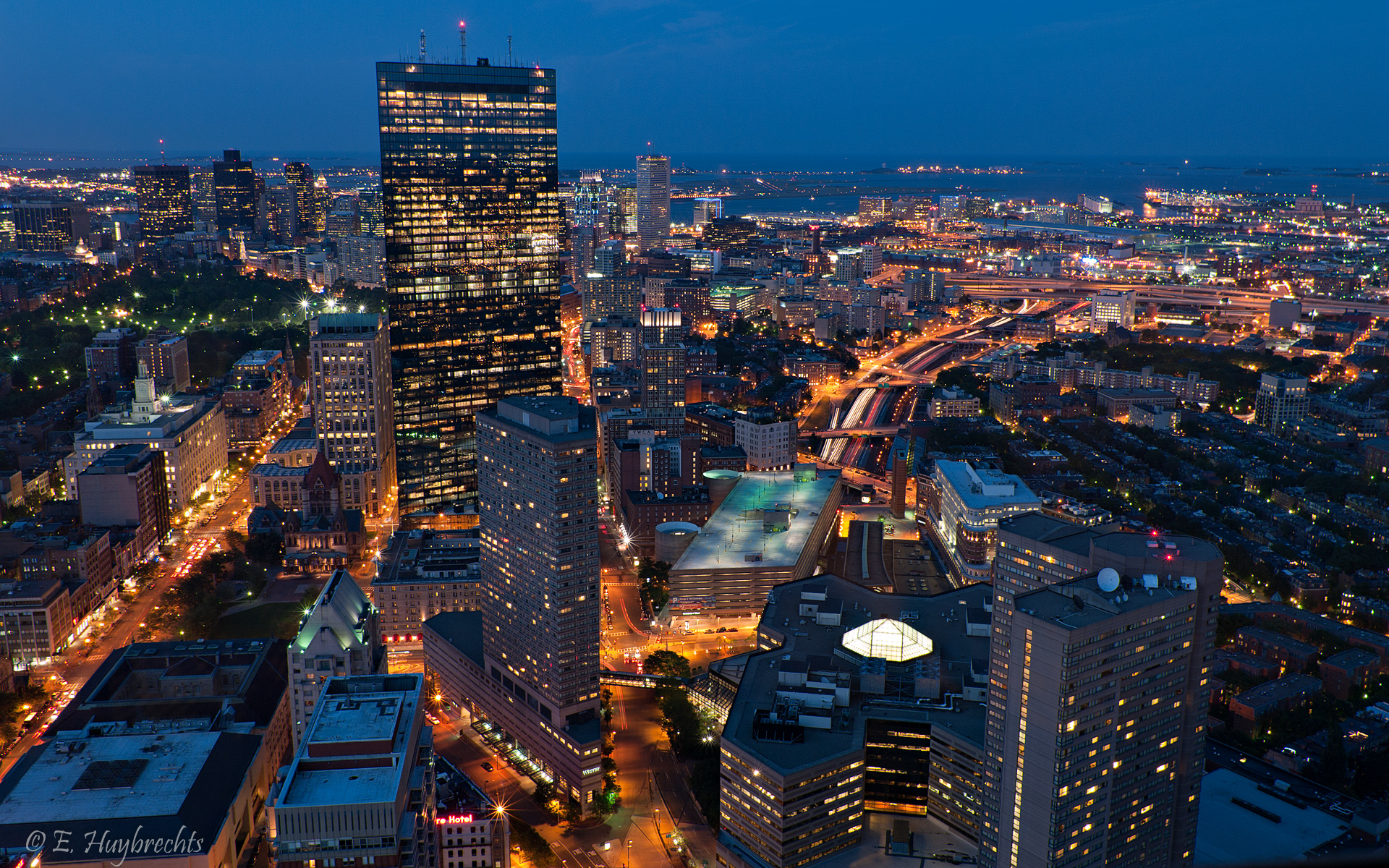 Boston skyline at blue hour, aerial view of the Back Bay skyscrapers and city lights